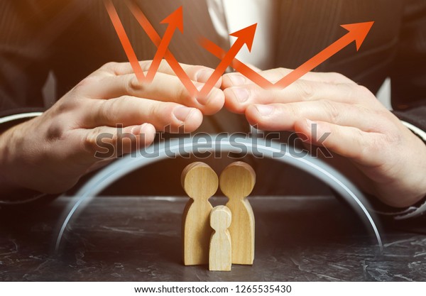 Insurance agent holds hands over family. The\
concept of insurance of family life and property. Health care.\
Security and Property Protection. Family care and helping hand\
concept. Health\
insurance.