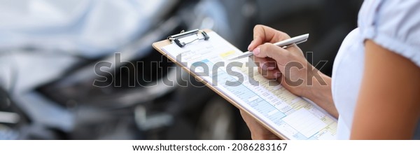 Insurance agent inspects damaged vehicle. Car
insurance concept