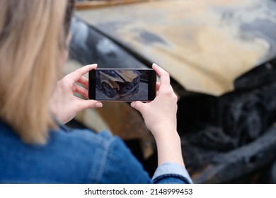 Insurance Agent Or Investigator Takes Picture On Smartphone Of Car After Arson