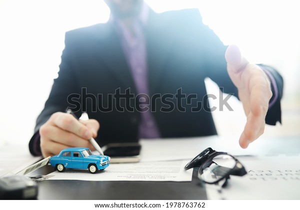 The\
insurance agent signs a document. Car insurance policy. Auto\
insurance policy. Forms registration of the\
contract.