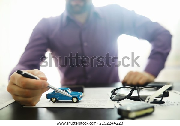 The\
insurance agent signs a document. Car insurance policy. Auto\
insurance policy. Forms registration of the\
contract.