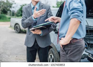 Insurance agent working claim process in payment on from parties. Insurance agent examine damaged car and customer checking on report claim form after accident, Accident and insurance claim concept.