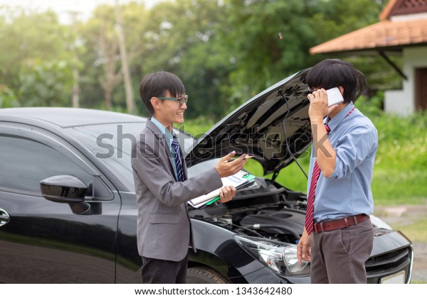 Insurance agents check for damaged cars for\
car insurance customer. Car\
insurance.