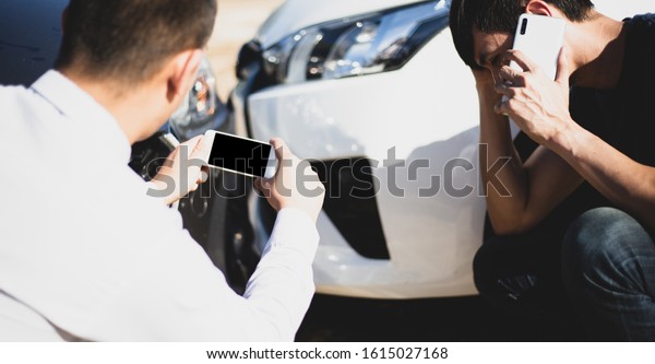Insurance agents inspect for damage to cars that\
collide on the road to claim compensation from driving accidents,\
Insurance concept.