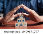 Insurance and assurance concept, Businessman protect wooden blocks with insurance icons for medical, life, car, home, travel insurance.