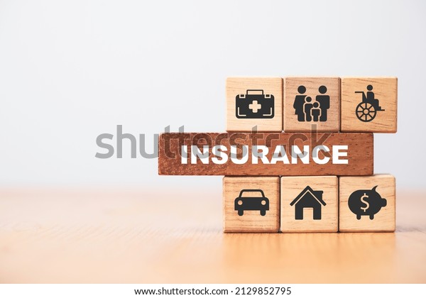 Insurance and assurance icon including family\
health real estate car and financial print screen on wooden cube\
bock for risk management\
concept.