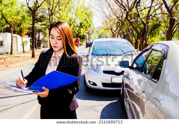 Insurance\
business female professional representative customer service to\
inspect the area responsible for car insurance during an accident\
Write down the information to the\
clipboard.
