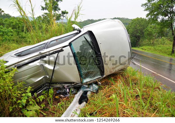 insurance car accident scene / the van car accident\
on the road with overturned on the street slippery road after rain\
and wet
