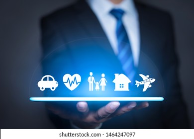 Insurance concept. Businessman with car, family, life and health insurance icons.