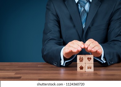 Insurance concept. Businessman with protective gesture and insurance icons on wooden cubes: family and life, health, financial, and car insurance.