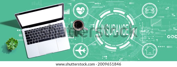 Insurance\
concept with a laptop computer on a\
desk