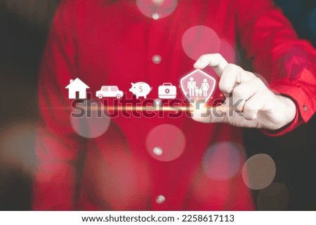 insurance concept, a man's hand showing protection shield icon for family  To show decisions about life insurance, work, money, health, home and car, plan the future for yourself and your family.