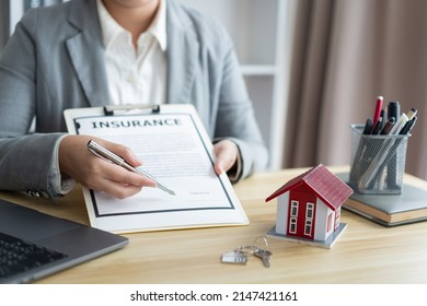 Insurance Concept The Realtor Pointing His Pen And Suggesting His Client To Sign The Name.