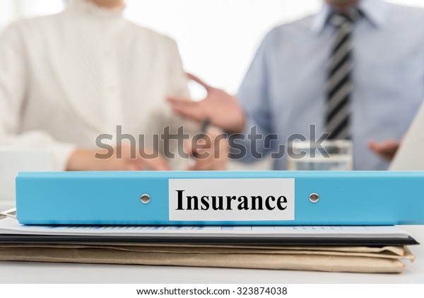 Insurance documents file with Insurance brokers\
are meeting in\
office.