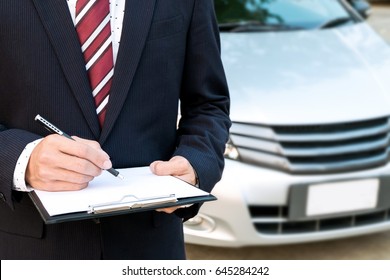 An Insurance Expert Employee Working With A Car At The Outdoor