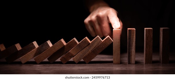 insurance with hands protect domino. Businessman hands stop dominoes falling in business crisis. business risk control and planning and strategies to run prevent insurance businesses.