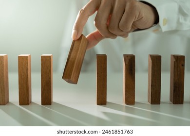 insurance with hands protect domino. Businessman hands stop dominoes falling in business crisis. business risk control and planning and strategies to run prevent insurance businesses.