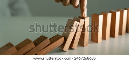 insurance with hands protect domino. Businessman hands stop dominoes falling in house crisis. business risk control and planning and strategies to run prevent insurance businesses.