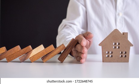 insurance with hands protect a house. Home insurance or house insurance concept - Shutterstock ID 1722648745