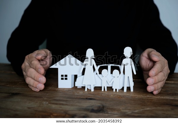 Insurance\
house, car and family health live concept. The insurance agent\
presents the toys that symbolize the\
coverage.