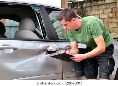 Insurance Mechanic At Work In Car Body Shop.