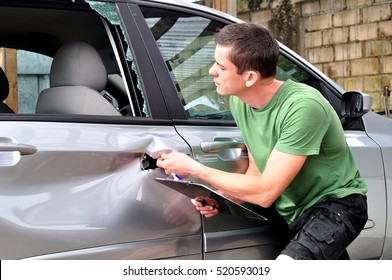 Insurance Mechanic At Work In Car Body Shop.