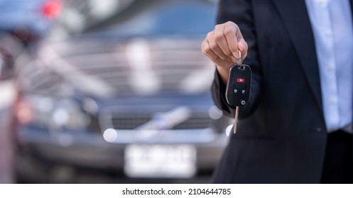 Insurance Officers Hand Over The Car Keys After The Tenant. Have Signed An Auto Insurance Document Or A Lease Or Agreement Document Buying Or Selling A New Or Used Car With A Car