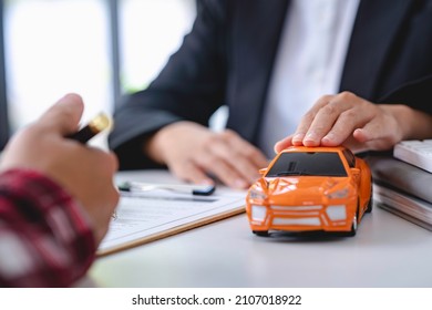 Insurance Officers Hand Over The Car Keys After The Tenant. Have Signed An Auto Insurance Document Or A Lease Or Agreement Document Buying Or Selling A New Or Used Car With A Car