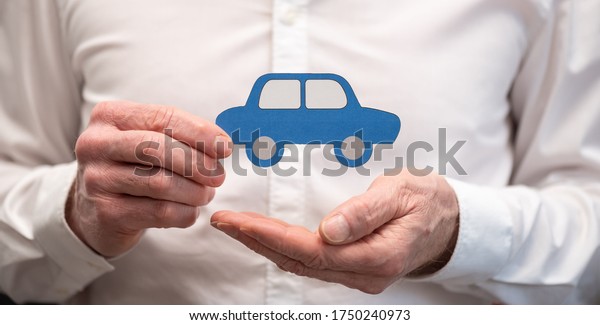 Insurer\
holding a paper car; Concept of car\
insurance