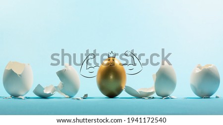 Intact golden egg among broken white eggs. The concept of reliability, resistance to adverse conditions.  Funny character. 