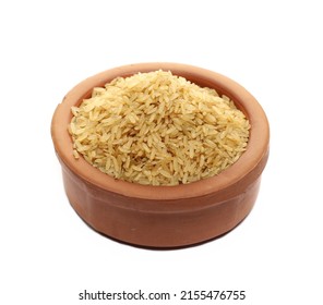 Integral uncooked rice pile in clay pot isolated on white   - Shutterstock ID 2155476755