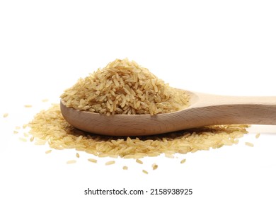 Integral uncooked rice pile in wooden spoon isolated on white   - Shutterstock ID 2158938925