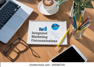 integrated marketing communications    (IMC) open book on table and coffee Business