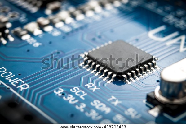 Integrated semiconductor microchip/\
microprocessor on blue circuit board representative of the high\
tech industry and computer\
science