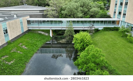 An integration of elements that acknowledges the importance of nature in a unique and dynamic composition within an academic setting as the site ties together both the physical structures and the ecological conditions in a contrived way.