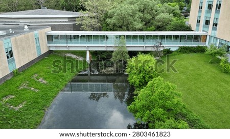 An integration of elements that acknowledges the importance of nature in a unique and dynamic composition within an academic setting as the site ties together both the physical structures and the ecological conditions in a contrived way.