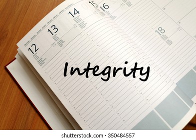 Integrity text concept write on notebook with pen