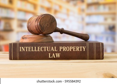 Intellectual Property law books and a gavel on desk in the library. concept of legal education.