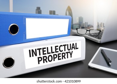 INTELLECTUAL PROPERTY Office folder on Desktop on table with Office Supplies.
