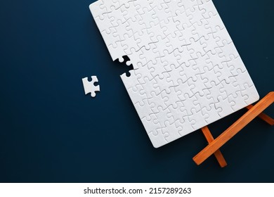 Intellectual puzzles. The puzzle empty. The hand puts together puzzle pieces. Brain training. - Shutterstock ID 2157289263