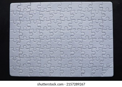 Intellectual puzzles. The puzzle empty. The hand puts together puzzle pieces. Brain training. - Shutterstock ID 2157289267