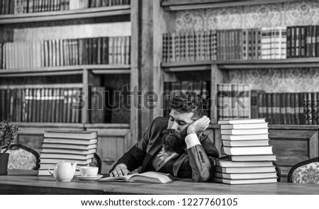 Intellectual work concept. Bearded man in library has intellectual work.