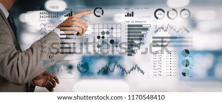 Intelligence (BI) and business analytics (BA) with key performance indicators (KPI) dashboard concept.business documents on office table with smart phone and digital tablet and graph on wide screen