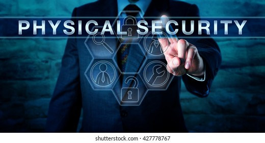 Intelligence Officer Is Pushing PHYSICAL SECURITY On An Interactive Transparent Control Screen. Business Metaphor And Technology Concept. Application Icons With Security Tools Arranged In A Cycle.