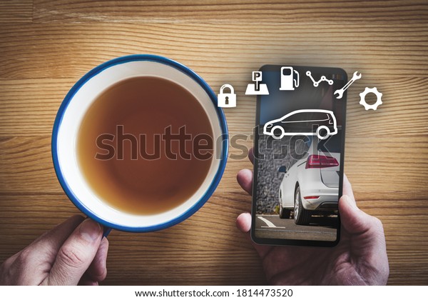 Intelligent car app on smart phone
concept, intelligent vehicle and smart cars concept. Person with
smart phone during breakfast, car on smart phone
background.