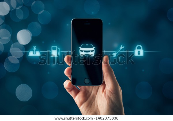 Intelligent car smart phone app concept,\
intelligent vehicle and smart cars concept. hand with smart phone\
with symbol of the car and information about parking location,\
fuel, service and\
security.