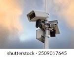 Intelligent CCTV IP video security system, multi lense camera mounted on pillar, agaist sky background, advanced surveillance and reliable safety monitoring. Security systems for effective monitoring