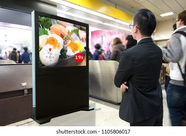 Intelligent Digital Signage , Augmented Reality Marketing And Face Recognition Concept. Interactive Artificial Intelligence Digital Advertisement Sushi Japanese Restaurant In Subway Or Sky Train.