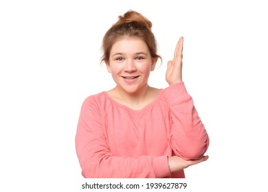 Intelligent Enthusiastic Teen Girl Raises Her Hand Up With A Happy Smile To Attract Attention And Answer A Question, Isolated On White Background