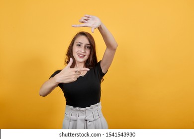 Intelligent Girl Being Artistic As She Is Framing Someone To Cast. She Looks Confident As She Knows How This Process Works, And She Is Observing Someone To Cast By Making A Frame Out Of Her Hands.